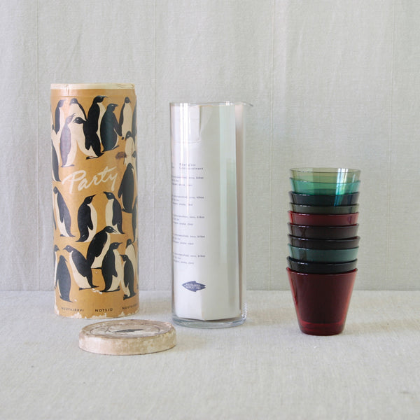 Kaj Franck model 1609 clear glass pitcher with ten model 2744 glasses in purple, green, red, turquoise and blue. Rare museum quality Finnish Modernist design.