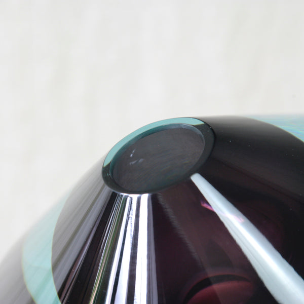 Close view of Kaj Franck's scarce KF 235 Lentävä lautanen showing the vase's mouth and hollow purple interior surrounded by deep transparent blue and clear flashed glass.