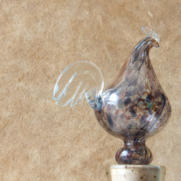 Detail showing the clear glass tail feathers of a rooster which is the decanter stopper to a "Kukkopullo" or “Rooster bottle” designed by Kaj Franck for Nuutajärvi glassworks, Finland. This highly collectable piece of Nordic design was created in 1960.
