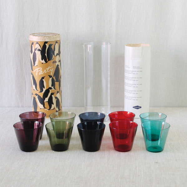 Colourful Kaj Franck Party-set comprising pairs of purple, green, red, turquoise and blue cocktail glasses with a clear glass pitcher.