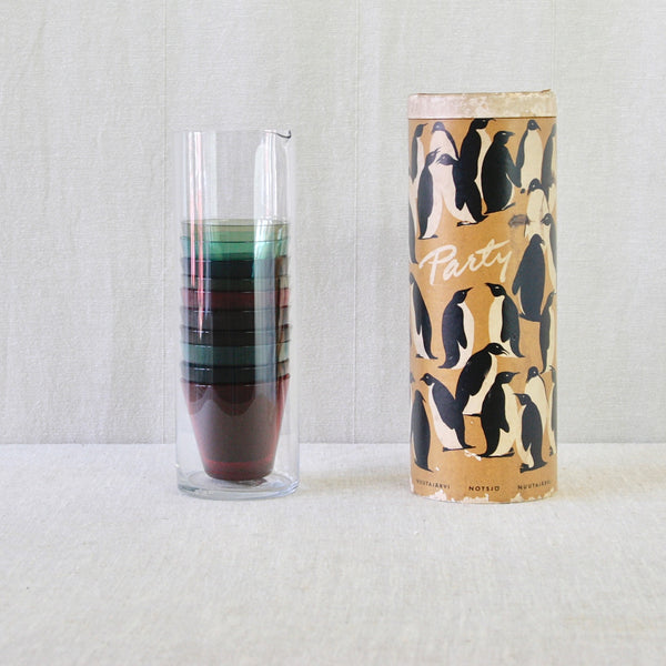 Complete vintage Kaj Franck Party-set for Nuutajärvi, with ten coloured cocktail glasses, clear pitcher and original packaging.
