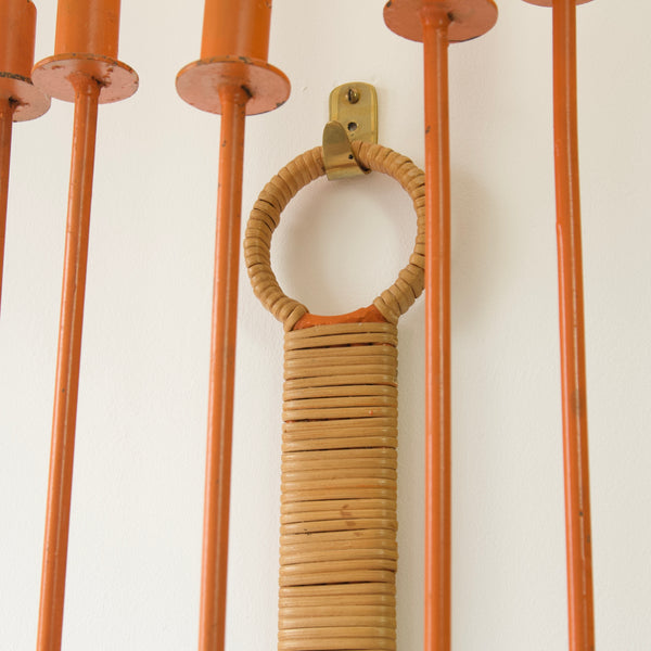 Detail of the cane wicker bound hanging loop on an Arthur Umanoff candelabra. This wall fixture not only illuminates but also captivates with its impressive size and bold design.
