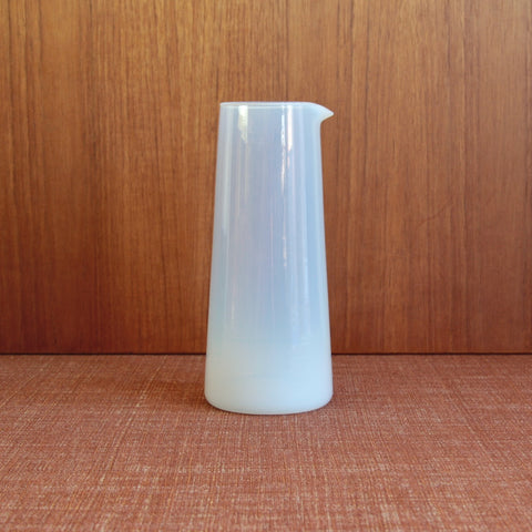 A large Opaline milk-glass carafe designed by Jacob Bang for Kastrup Glassworks, showing its clean conical form and Danish Modernist functionalism.