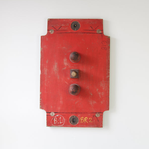 Wall-hung bright red painted industrial art sculpture, a vintage painted mould for machine parts