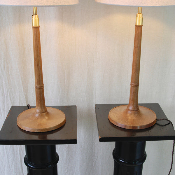 Esben Klint oak table lamp for Le Klint, showing the broad circular base, slender tapered stem and sculptural Danish Modern silhouette.