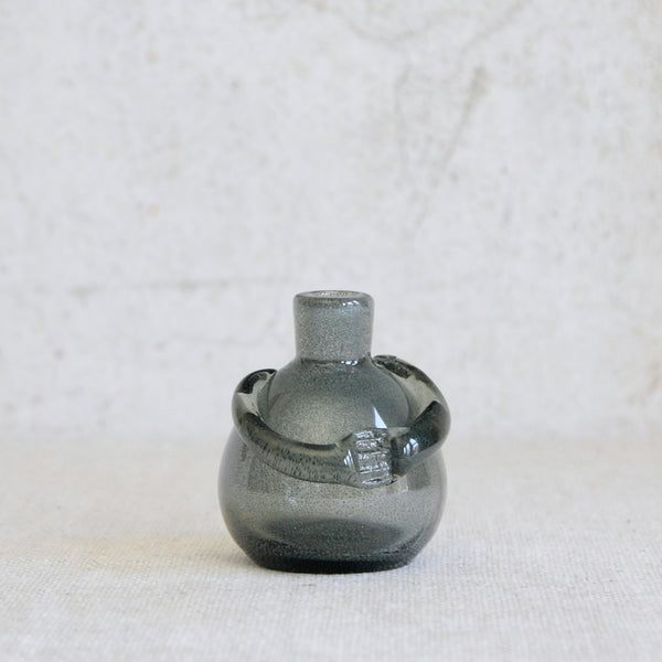 Head on profile image of an Erik Höglund human-shaped bottle vase from Boda, an important precursor to his later bubble-glass decanters.