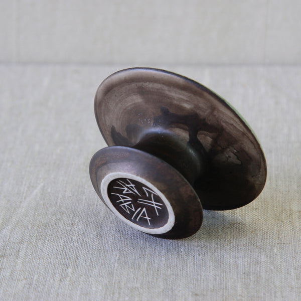 Sculptural stoneware candleholder by Liisa Hallamaa, its narrow waist expanding dramatically into a broad flared upper form.