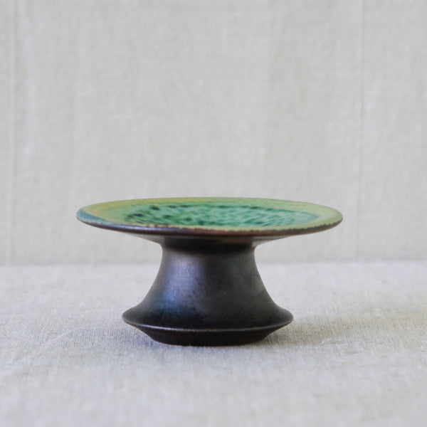 Flared ceramic candleholder by Liisa Hallamaa for Arabia, with an exaggerated sculptural silhouette designed to hold a dinner candle.