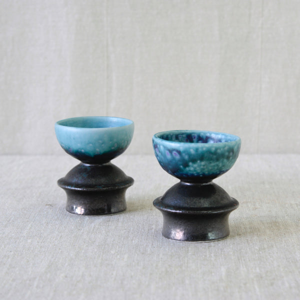 Liisa Hallamaa candleholder pair for Arabia Finland, handmade circa 1960 with sculptural hooped feet and rounded bowl-shaped tops.