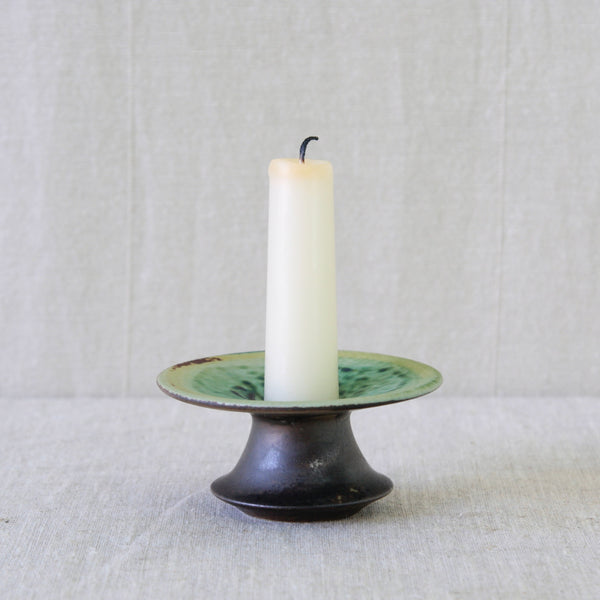 Mid-century sculptural candleholder handmade at Arabia Finland, with an exaggerated flared form and richly coloured glaze.