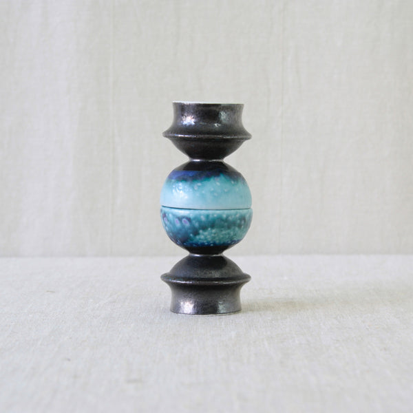 Sculptural ceramic candleholders by Liisa Hallamaa, each rising from a hooped foot through a narrow waist to a rounded upper bowl.