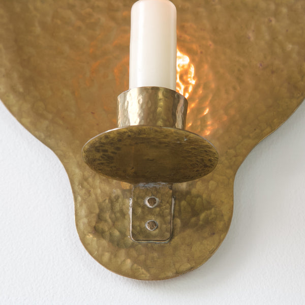 Hand-hammered brass wall sconce, capturing the essence of traditional Swedish craftsmanship. For sale in London from Nordic design gallery Art & Utility.