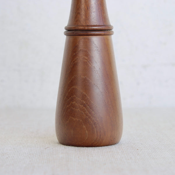 Wooden pepper grinder on a white background. Scandinavian vintage 1960s pepper mill Jens Quistgaard Dansk Designs model 879 collectible kitchenware