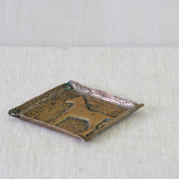 English folk art brass dish, extensively hand-hammered and decorated with a charming stylised horse motif at its centre.