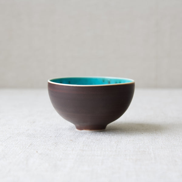 Mid century modern tea bowl from Arabia, Finland, with blue interior glaze. The piece was designed by Friedl Holzer-Kjellberg.