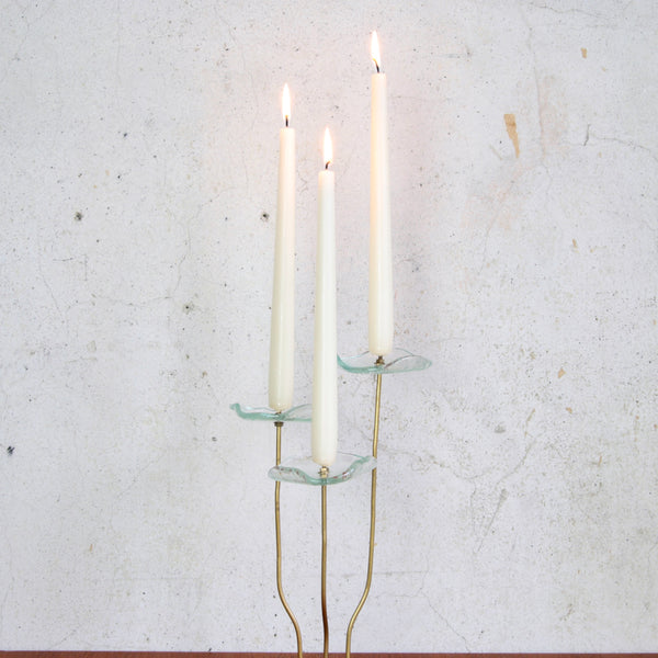 Handmade mid-century Scandinavian candlestick, sculptural brass with flower-shaped glass tops that act as drip pans.