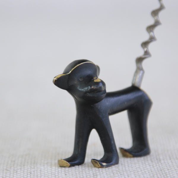 Detail of the face of a collector’s brass monkey corkscrew by Walter Bosse — mid-century Austrian design with black-golden patina, perfect for barware displays and vintage interiors.