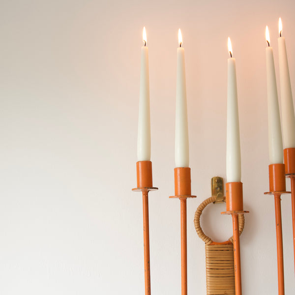 Close up showing a dinner candle in an Arthur Umanoff candelabra. Bring a touch of mid-century charm into your home with this iconic wall fixture by Umanoff for Raymor.