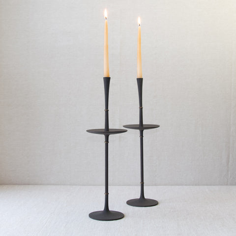 Profile image of a pair of very tall and slender black cast iron candlesticks designed by Jens Quistgaard for Dansk Design, Denmark, in the 1960s.