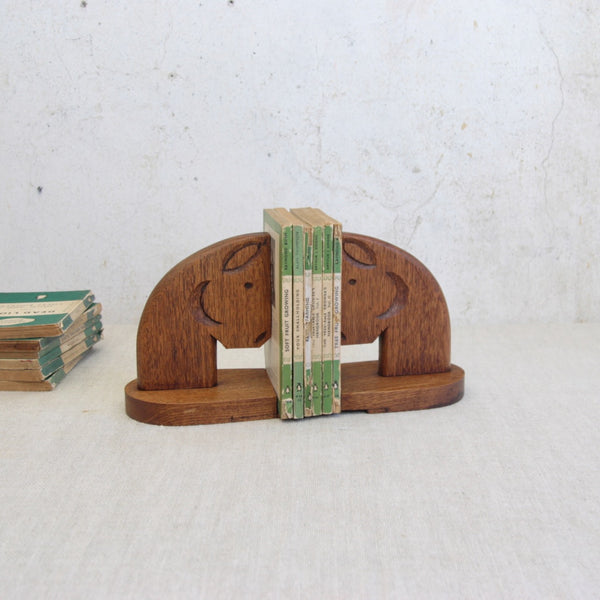 Top down artistic mood shot of a pair of collectible handmade horse head bookends in solid oak. This Modernist British mid-century design and many other for sale in the UK from design gallery Art & Utility.
