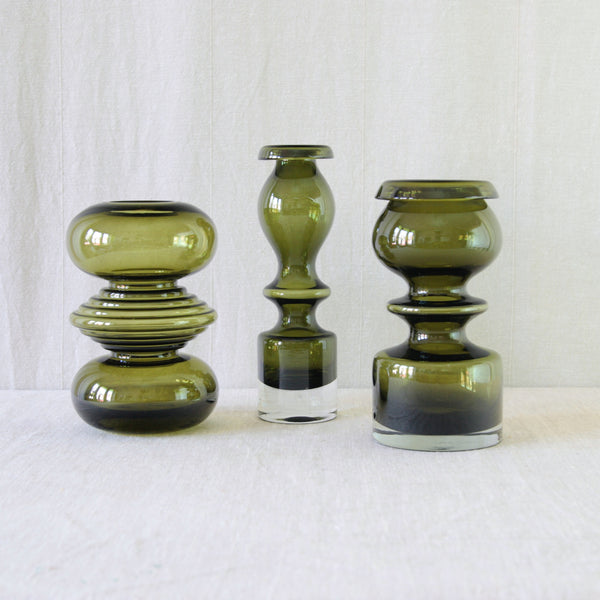 Group of Nanny Still olive green vases for Riihimäki Glassworks Finland, an expressive collection from the early 1970s, including 'Tiimalasi' and 'Pompadour' vases. 