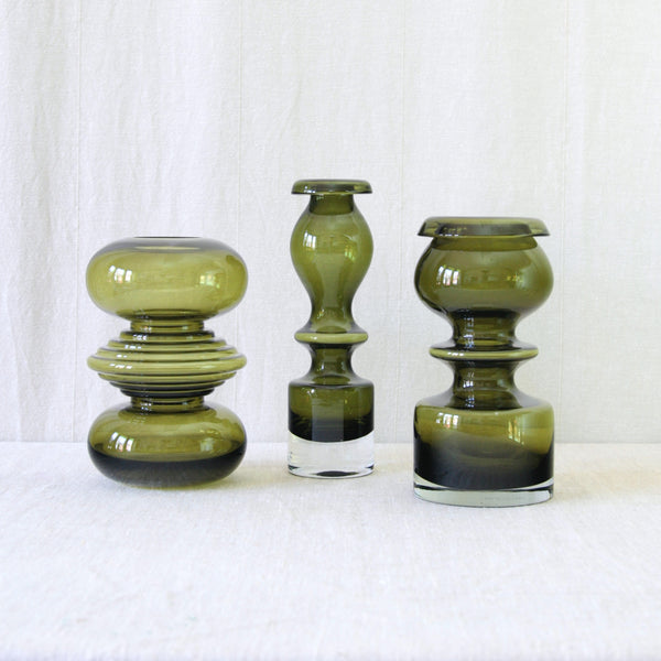 Nanny Still Pompadour and Tiimalasi vases for Riihimäki Finland, with a richly coloured olive green body and playful, retro aesthetic.