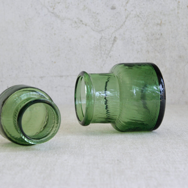 Artistic shot of collectible Neptuna glass vases by Nanny Still for Riihimäen Lasi, Finland, combining optical texture with clean geometric form.