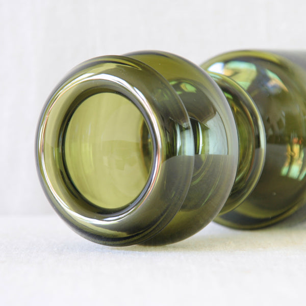 Detail of folded rim on 1960s Finnish Modernist glass by Nanny Still, combining rich olive green colour with a bold and highly sculptural hooped form.
