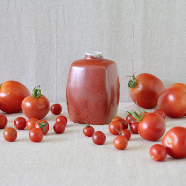 Vermilion Royal Copenhagen vase by Nils Thorsson with similarly coloured tomatoes