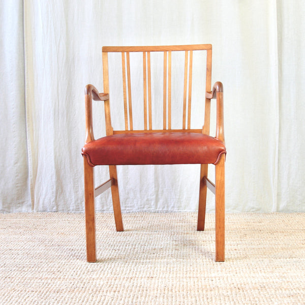 Head on shot Ole Wanscher 1942 Fritz Hansen chair showing the sculptural transition from the curved armrests into the upright front supports.