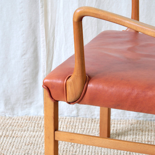 Detail of armrest and piping on seat of an Ole Wanscher Model 1675 spindle-back chair in beech, designed for Danish furniture manufacturer Fritz Hansen in 1942.