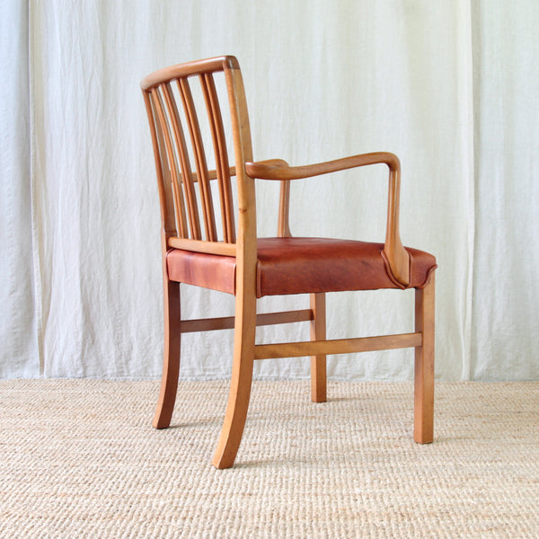 Rear view of Ole Wanscher's Model 1675 for Fritz Hansen, showing four pairs of slender wooden spindles and the gently curved top rail.