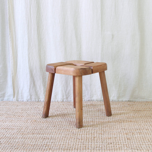 1950s Finnish pine stool by Olof Ottelin, with substantial sections of timber arranged around large openings designed for water drainage.