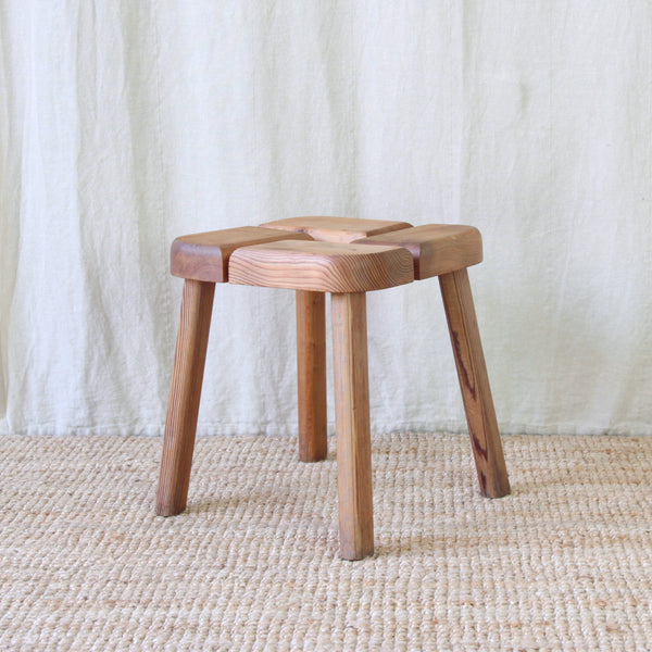 Architectural pine stool by Finnish designer Olof Ottelin, with a graphic interlocking seat supported by simple wooden legs.