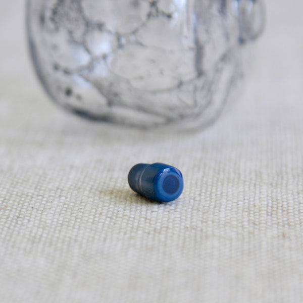 Detail of candy-cane glass stopper from a Scandinavian Modernist Orrefors bottle with seaweed like bubble patterns. Nordic design by Ingeborg Lundin. For sale in the UK.