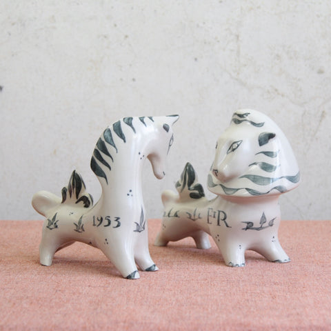 Lead image of a pair of striking Modernist lion and unicorn figures by Susan Parkinson, inspired by Arnold Machin's Zodiac Bull.