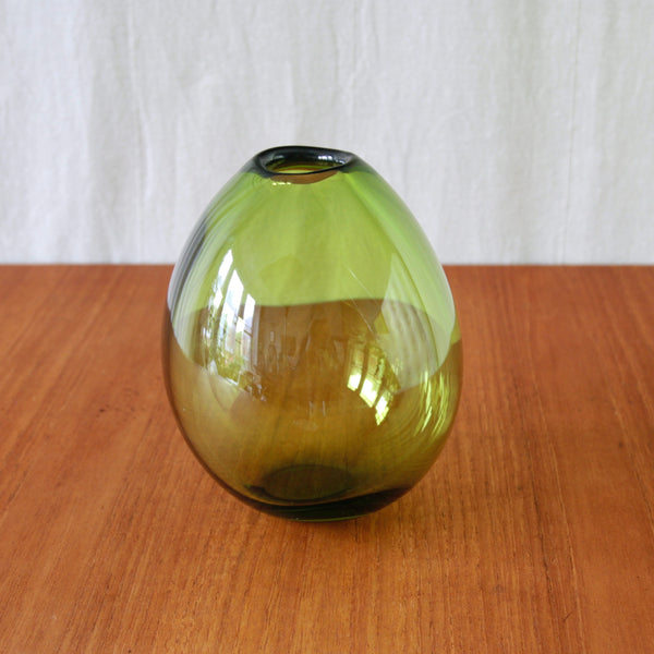 Per Lütken Drop Vase in Holmegaard May Green, its vibrant green glass emphasising the design’s distinctive inflated silhouette.