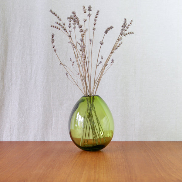 Organic green glass vase by Per Lütken for Holmegaard, with a softly inflated asymmetric form characteristic of Danish Modern glass.