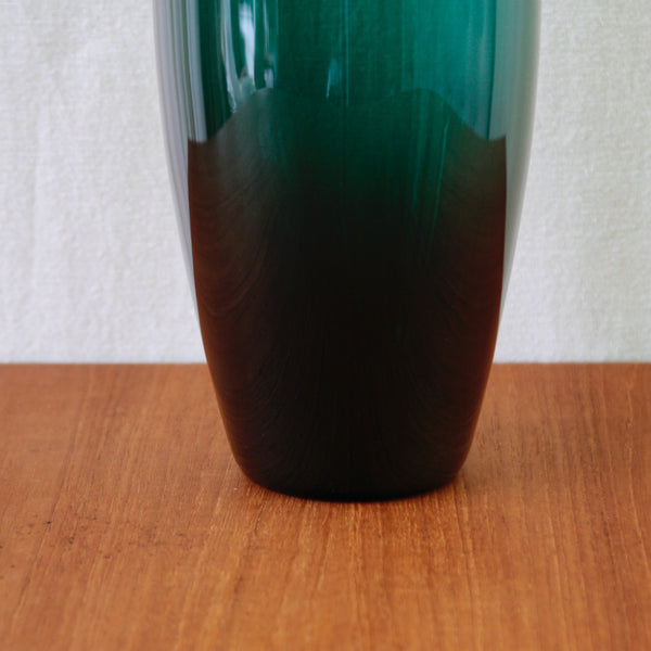 Free-blown Grønland vase designed by Per Lütken for Holmegaard in 1960, with a towering elliptical form in dark green glass.