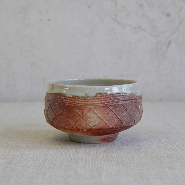 Hand-thrown stoneware chawan by Phil Rogers with naturalistic surface variations from wood firing.