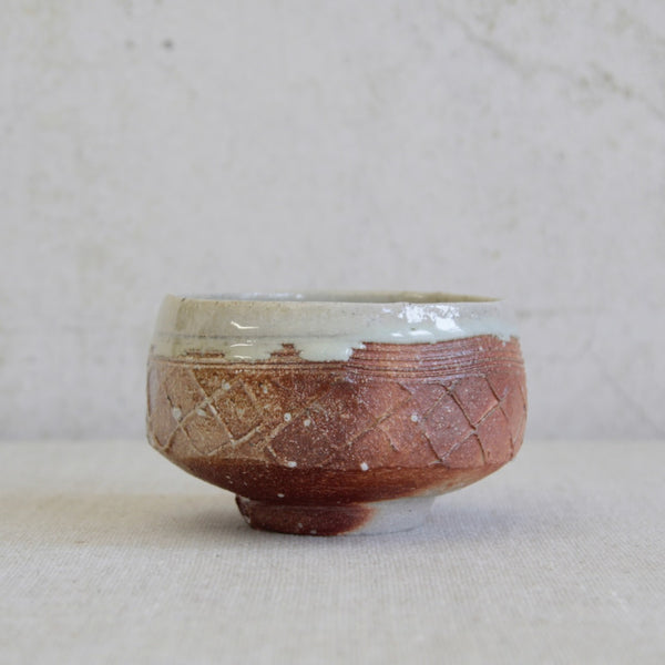 Footed stoneware bowl by Phil Rogers with Anglo-Oriental influence and beautifully textured glaze contrast.