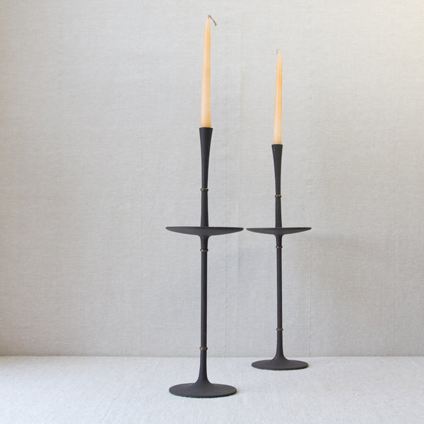 Profile image of a very tall and elegant pair of MidCentury Modern candlesticks designed by Danish designer Jens Quistgaard. These candle holders are one of the finest examples of 1960s Nordic candlesticks in metal. This Quistgaard design and many other for sale in London from Nordic design gallery Art & Utility.