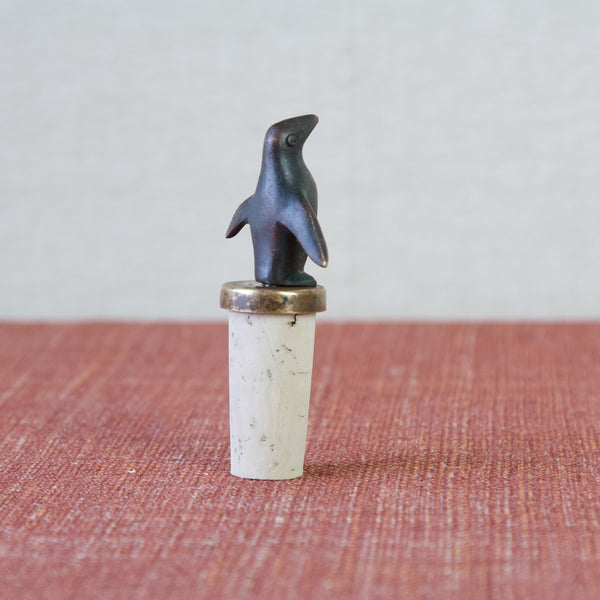 Image showing the reverse of a black patinated brass penguin bottle stopper. Enhance your home's aesthetic with the timeless appeal of Walter Bosse's design.