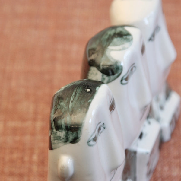 Looking down on to the heads in a Susan Parkinson porcelain sculpture depicting British commuters, an iconic post-war Modernist work influenced by contemporary studio ceramic movements.