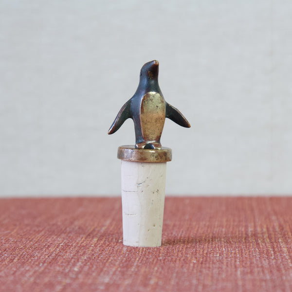 Head on shot of a Walter Bosse bottle stopper in the form of a penguin with its wings held out at its side.