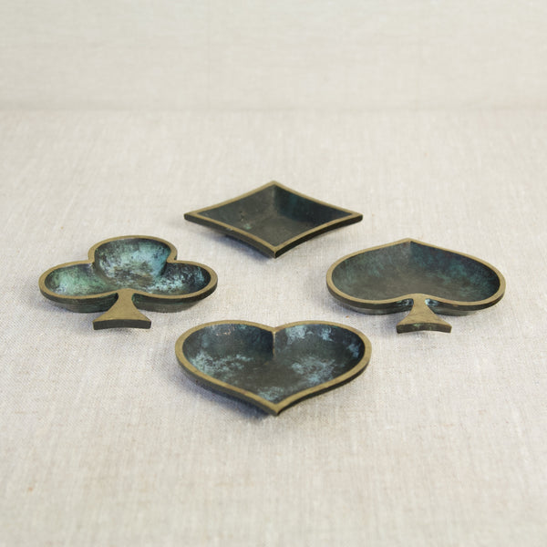 Vintage charm in a set of four modernist brass ashtrays, inspired by iconic playing card suits, crafted with precision and elegance in West Germany during the 1960s.