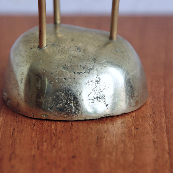 Detail of cast brass base on a collectible Scandinavian candle holder, mid-century Swedish design.