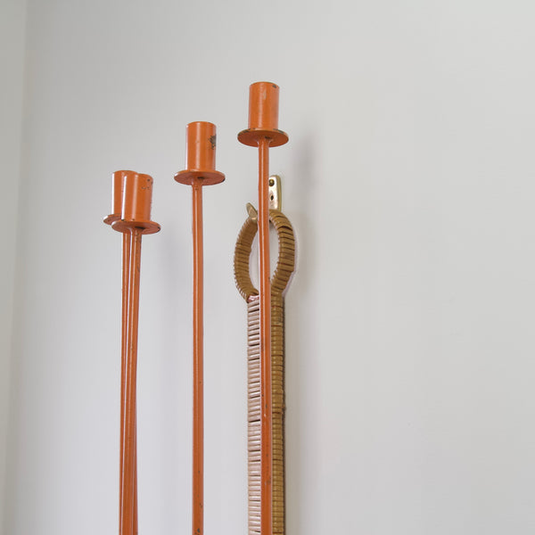 Angled image of an Arthur Umanoff candelabra without candles. Enliven your surroundings with the vibrant energy of Umanoff's orange enamel finish.