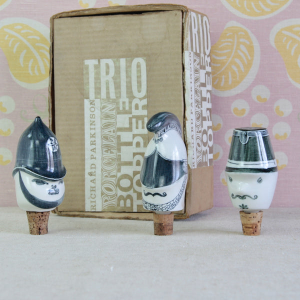 Three characterful Parkinson Pottery porcelain bottle stoppers from the 1950s, modelled as a British Policeman, Cavalry Officer and French Gendarme.