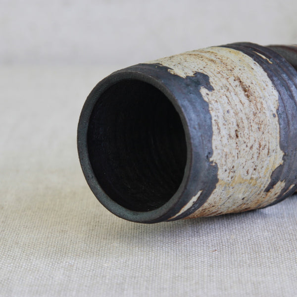 Cylindrical mouth on a ceramic vase with textured surface Annikki Hovisaari Hourglass / Diablo Vase with Organic Iron-Rich Glaze. Scandinavian design at its best.